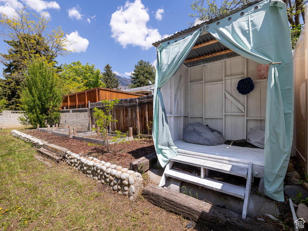 View of yard featuring a garden and fence