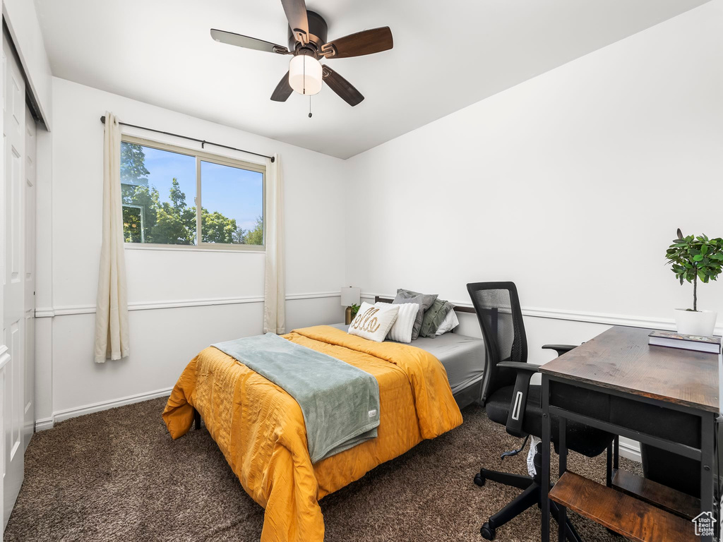 Bedroom with ceiling fan, baseboards, carpet, and a closet