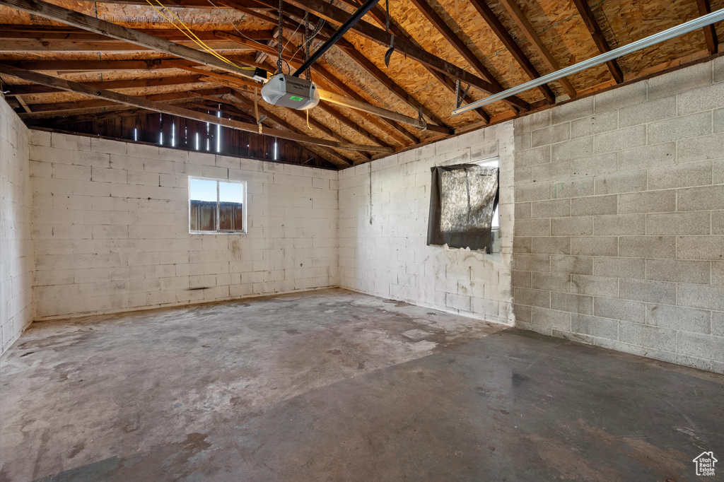 Below grade area featuring a garage and concrete block wall
