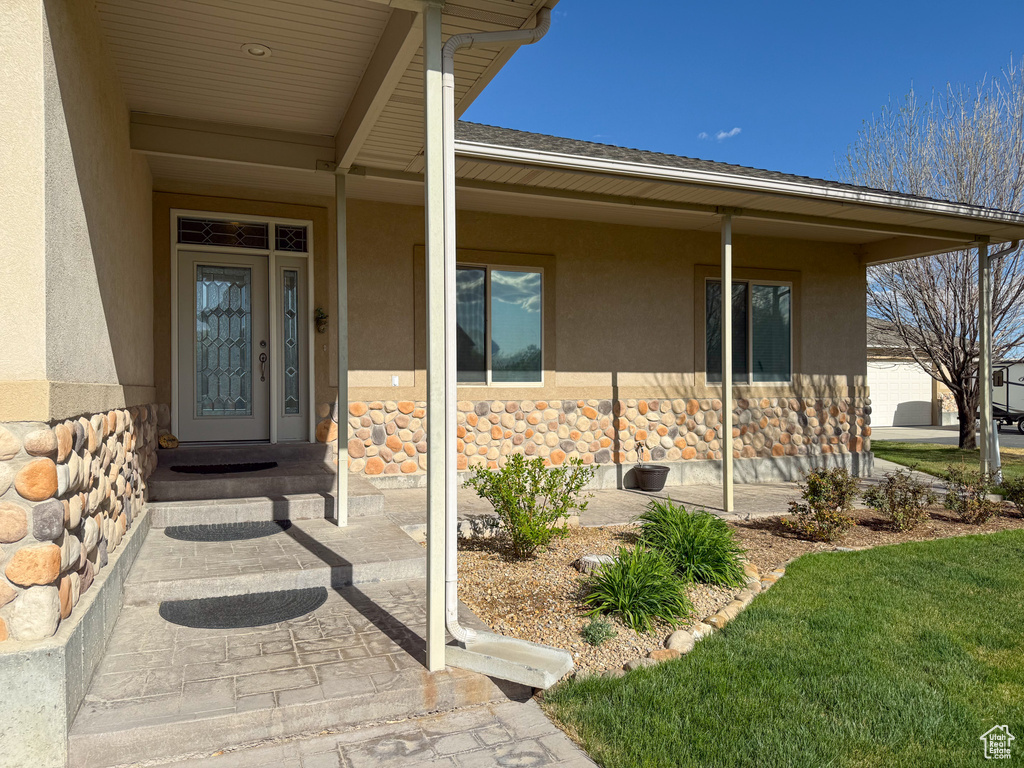 Property entrance with stucco siding and stone siding
