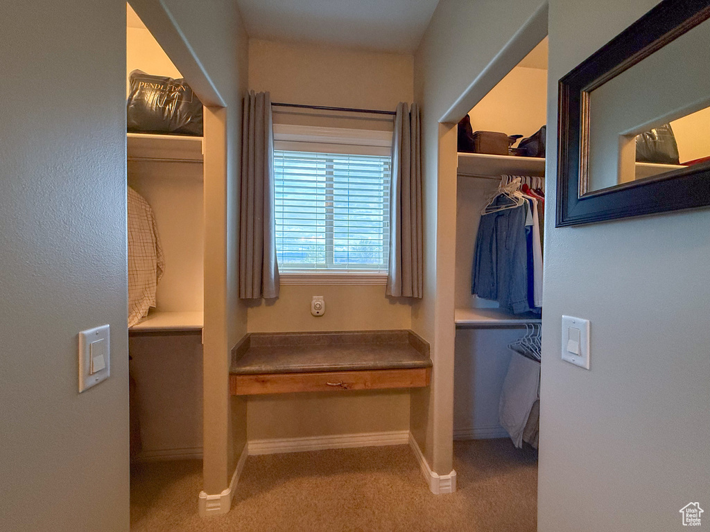 Bathroom with a walk in closet and baseboards
