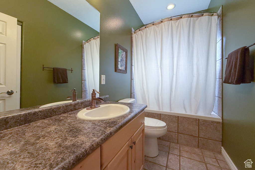 Full bath featuring tiled shower / bath combo, toilet, a wealth of natural light, and vanity