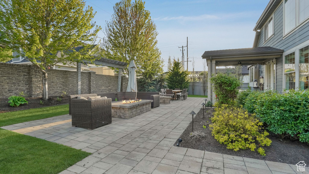 View of patio / terrace with fence and a fire pit