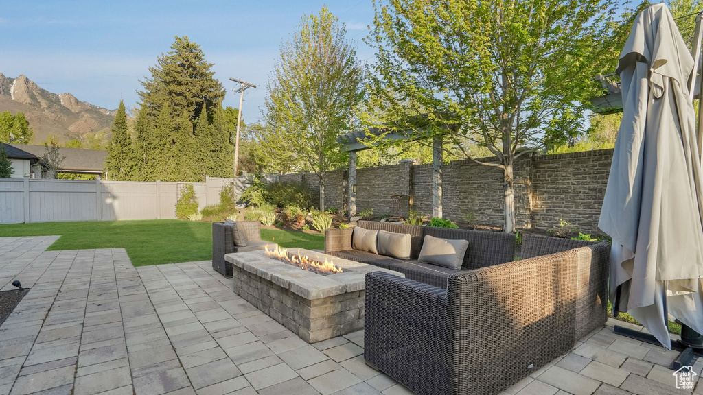 View of patio featuring a fenced backyard and an outdoor living space with a fire pit