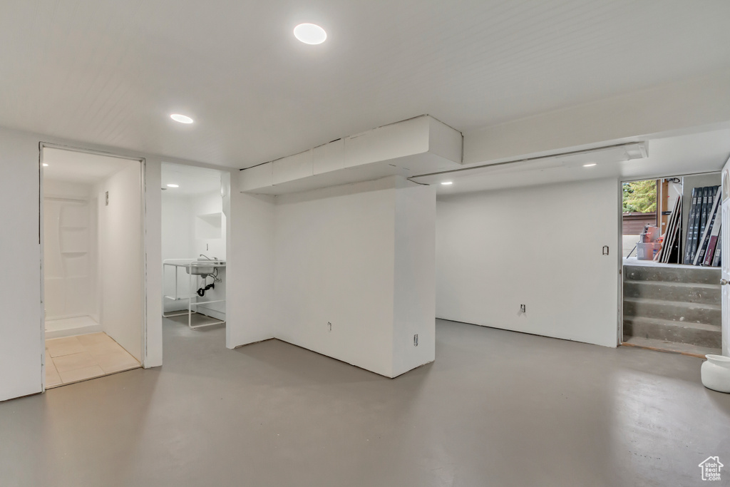 Basement with stairway and recessed lighting