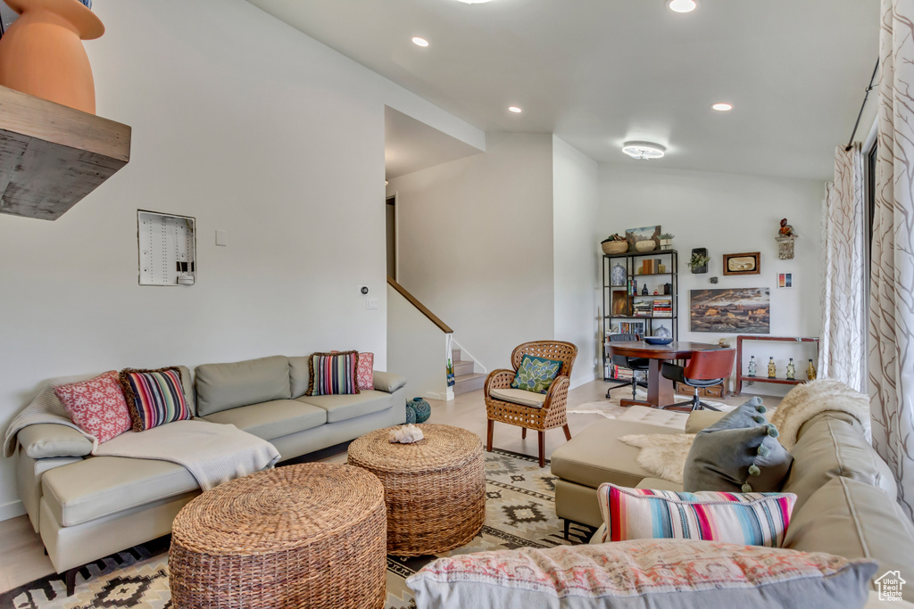 Living area featuring recessed lighting, baseboards, and stairway