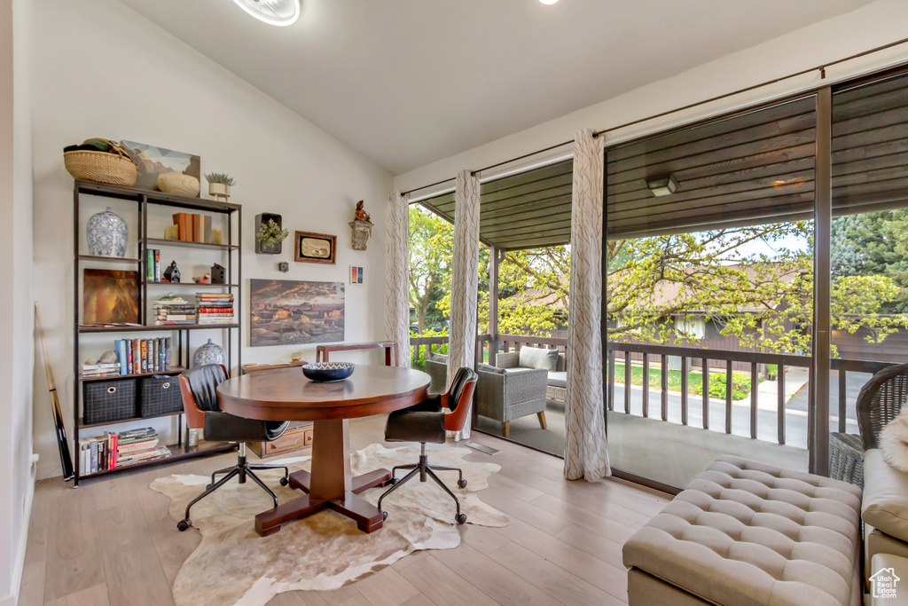 Dining room featuring wood finished floors and lofted ceiling