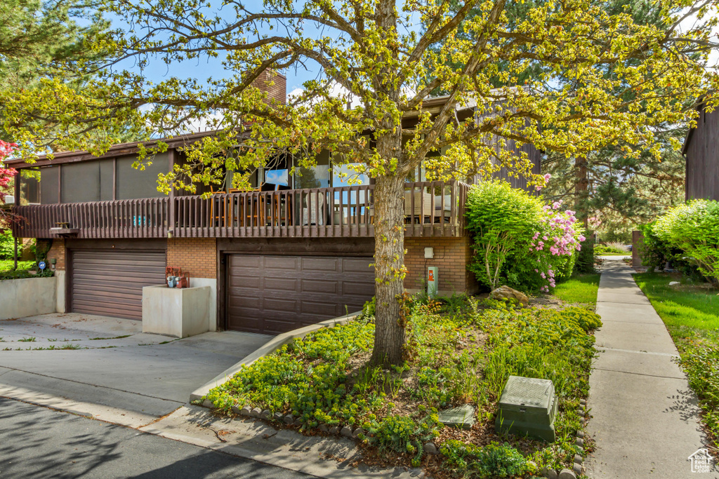 View of front facade with concrete driveway, brick siding, and a garage