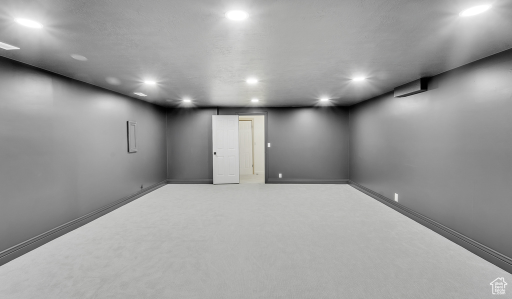 Finished basement with recessed lighting and baseboards