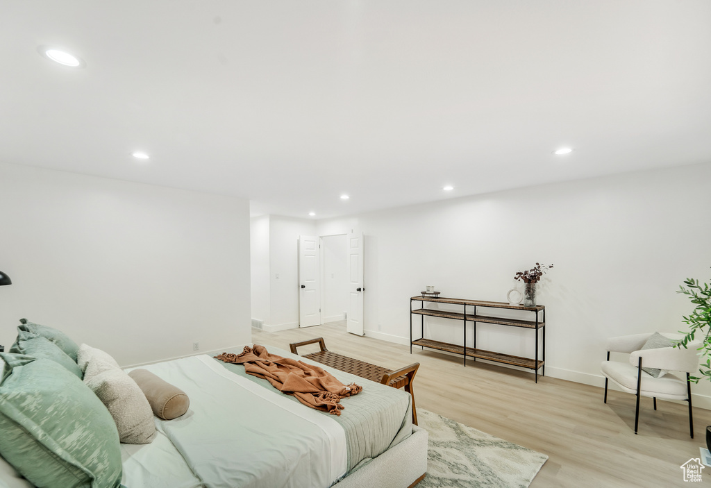 Bedroom with baseboards, recessed lighting, and light wood-style flooring