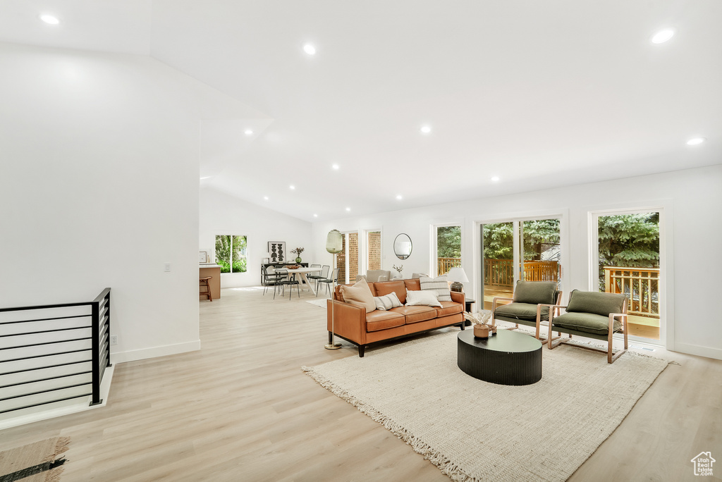 Living area featuring recessed lighting, light wood finished floors, baseboards, and vaulted ceiling