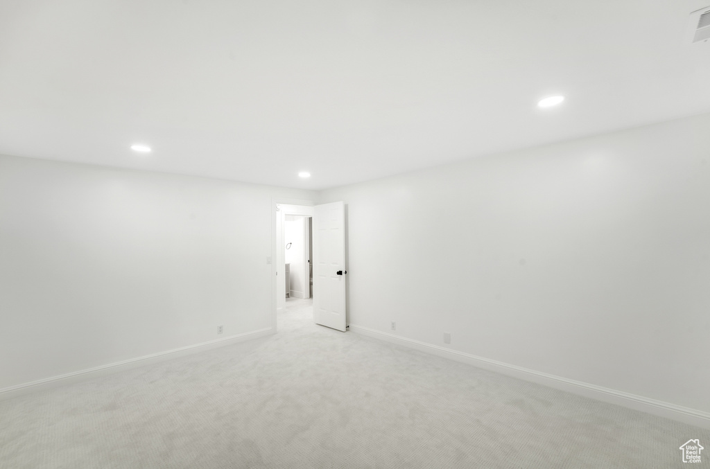 Unfurnished room featuring recessed lighting, baseboards, and light colored carpet