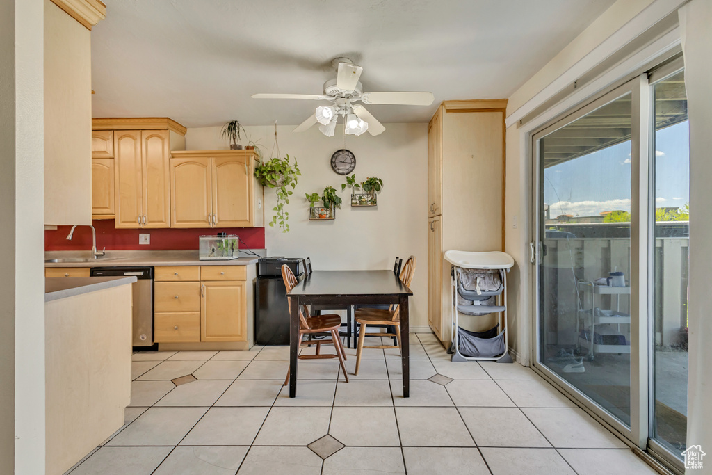 Kitchen featuring a sink, light brown cabinets, a ceiling fan, and dishwasher
