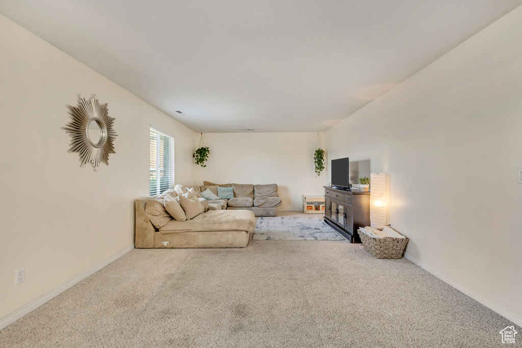 Carpeted living room featuring baseboards