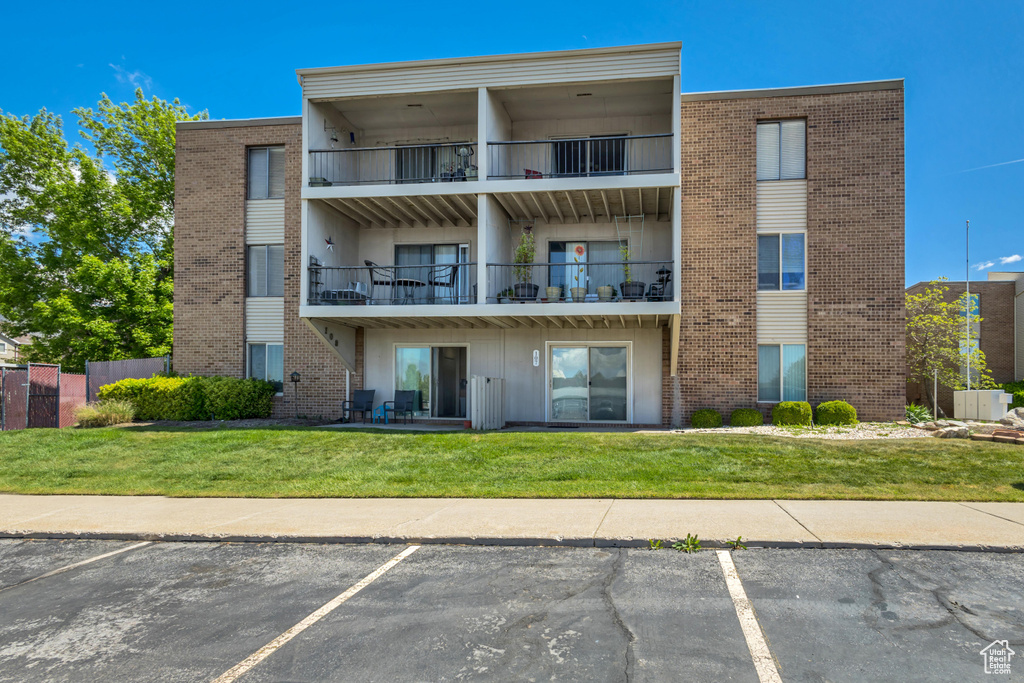 View of property with uncovered parking