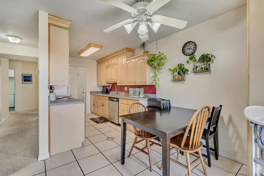 Kitchen featuring light brown cabinetry, stainless steel dishwasher, a ceiling fan, and light tile patterned flooring