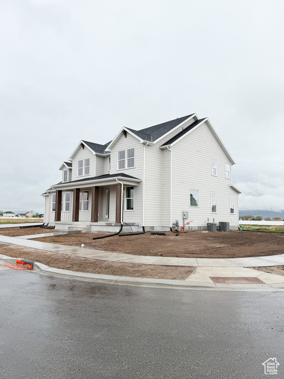 View of front of property featuring central air condition unit and a porch