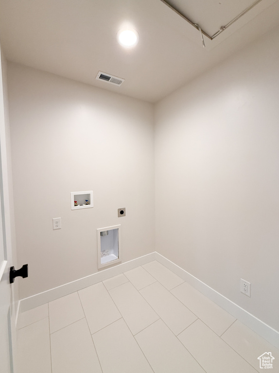 Clothes washing area featuring washer hookup, baseboards, electric dryer hookup, and laundry area