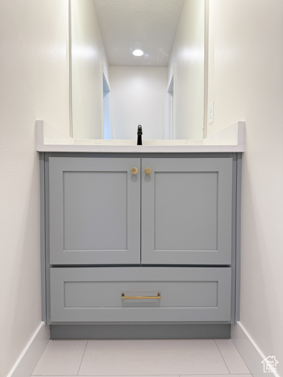 Room details with baseboards, vanity, and recessed lighting