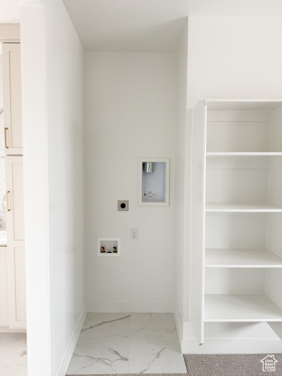 Clothes washing area with hookup for a washing machine, marble finish floor, baseboards, and electric dryer hookup