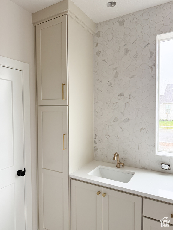 Bathroom with backsplash and vanity