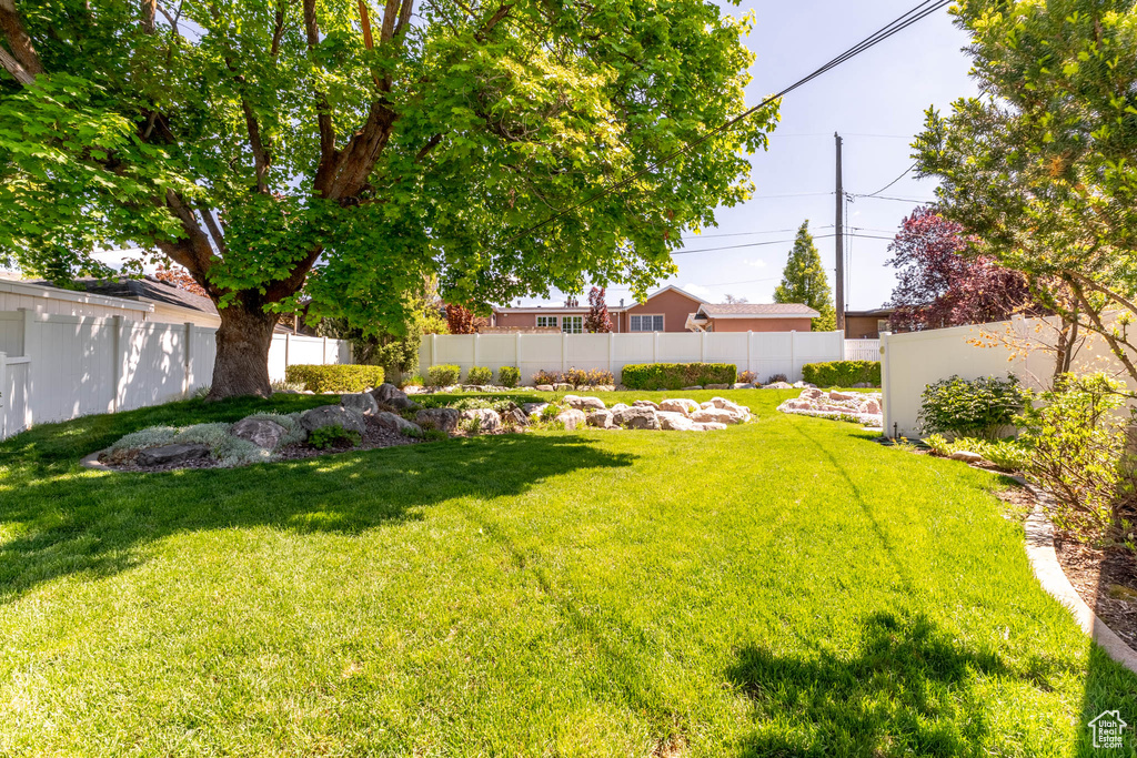 View of yard featuring fence