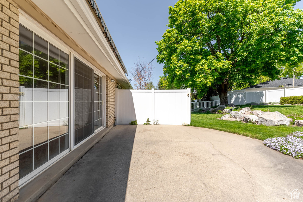 View of patio featuring fence