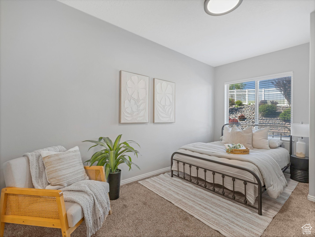 Bedroom featuring baseboards and carpet