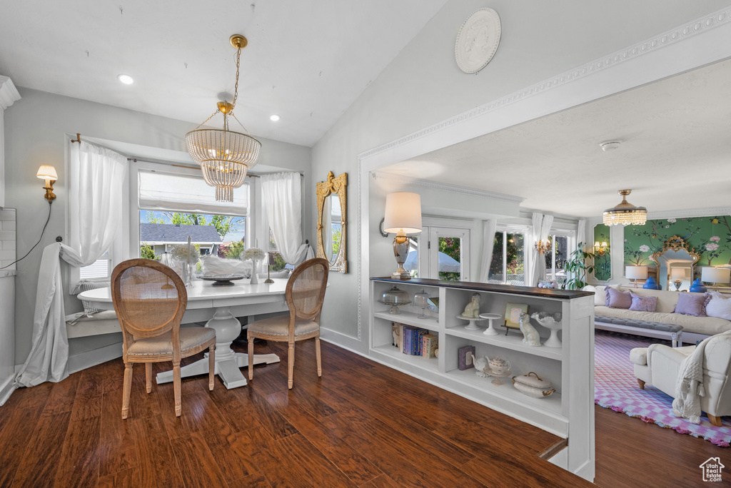 Dining space with a chandelier, recessed lighting, baseboards, wood finished floors, and lofted ceiling