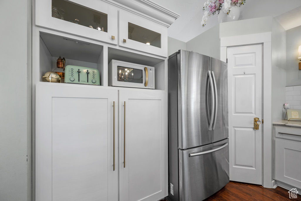 Kitchen featuring freestanding refrigerator, dark wood finished floors, and white microwave