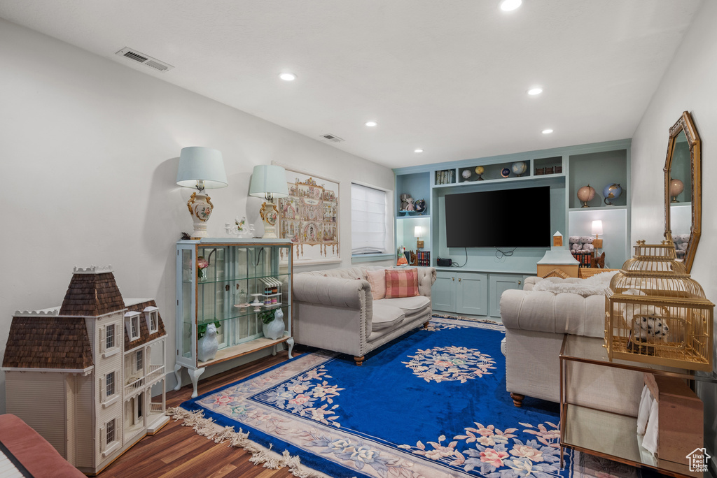 Living area with recessed lighting, wood finished floors, and visible vents