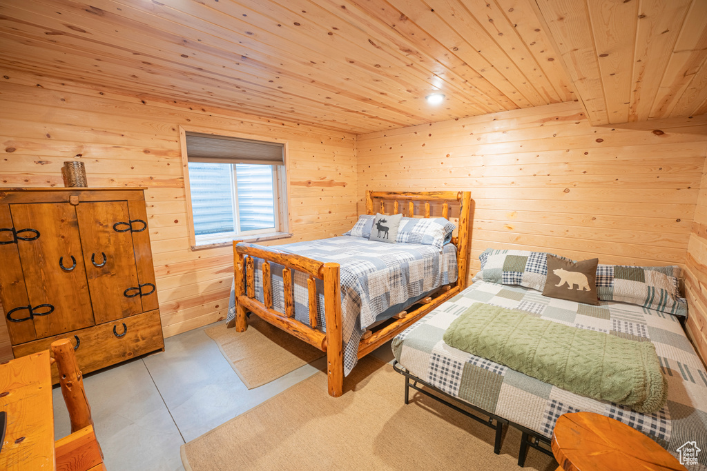 Bedroom with wooden walls and wood ceiling