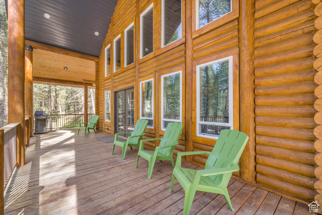 Sunroom / solarium featuring french doors and a wood stove