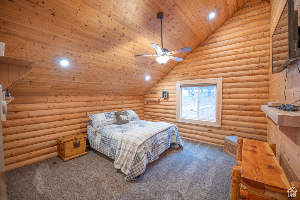 Bedroom with rustic walls, wood ceiling, and carpet