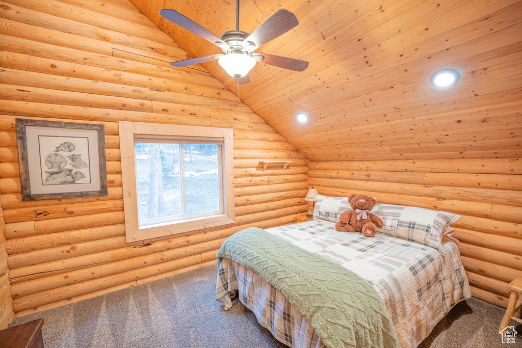 Bedroom with carpet flooring, log walls, lofted ceiling, and wood ceiling