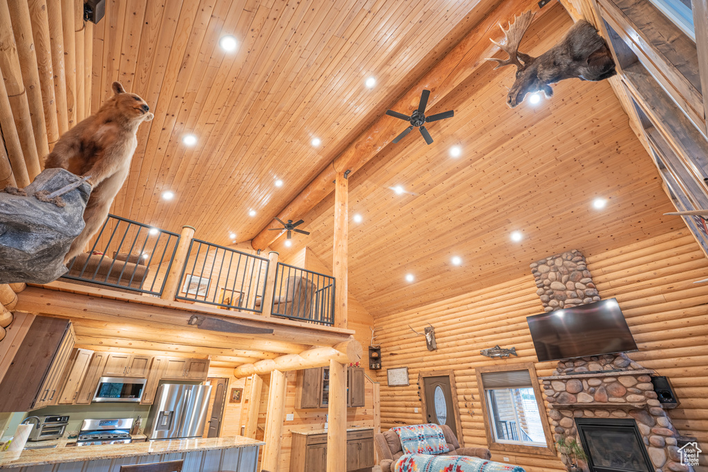 Living room with high vaulted ceiling, a ceiling fan, and recessed lighting