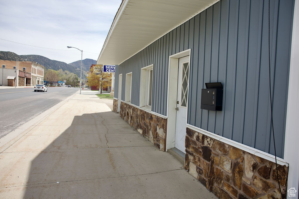 View of home\'s exterior featuring a mountain view, board and batten siding, and stone siding