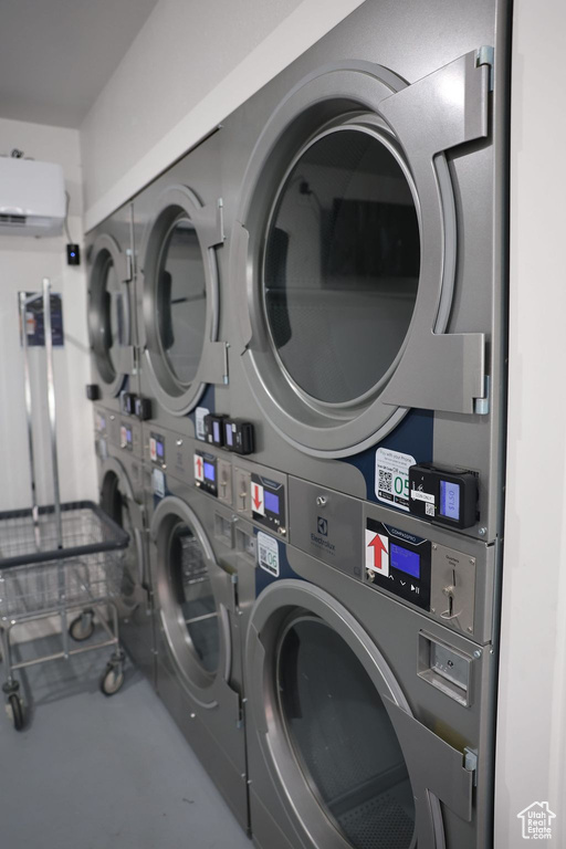 Shared laundry area with stacked washer and dryer