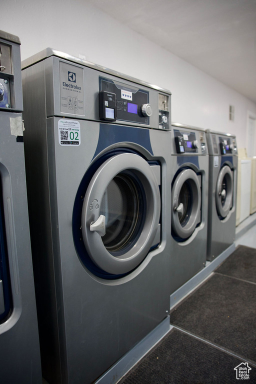 Shared laundry area with carpet floors and washing machine and clothes dryer