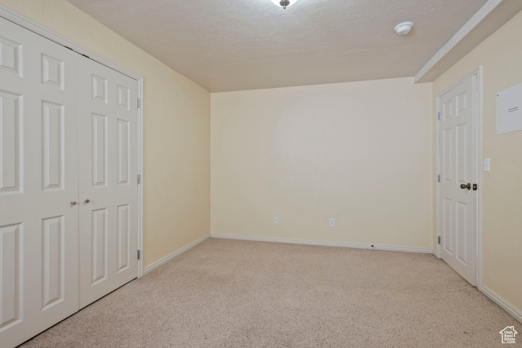 Unfurnished bedroom with a closet, baseboards, and carpet flooring