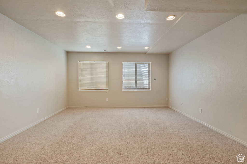 Unfurnished room featuring recessed lighting, baseboards, and light carpet