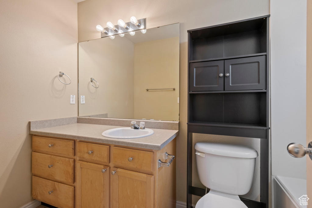 Bathroom featuring vanity and toilet