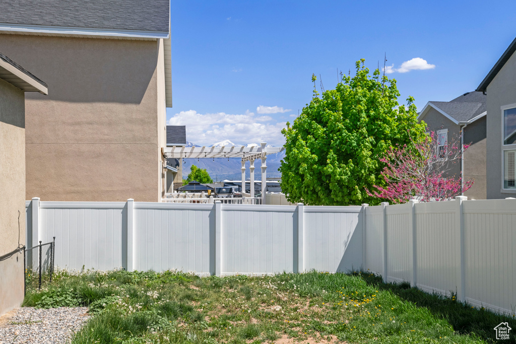 View of yard with a fenced backyard and a pergola