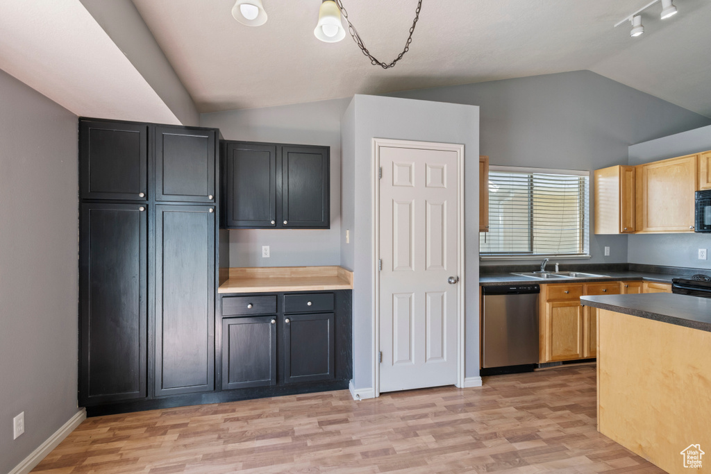 Kitchen featuring dark countertops, vaulted ceiling, a sink, black appliances, and light wood finished floors