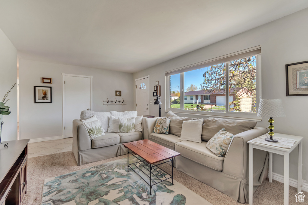 Living room with baseboards and light tile patterned floors