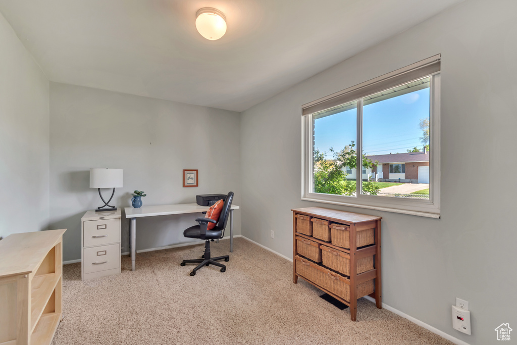 Carpeted office space with baseboards