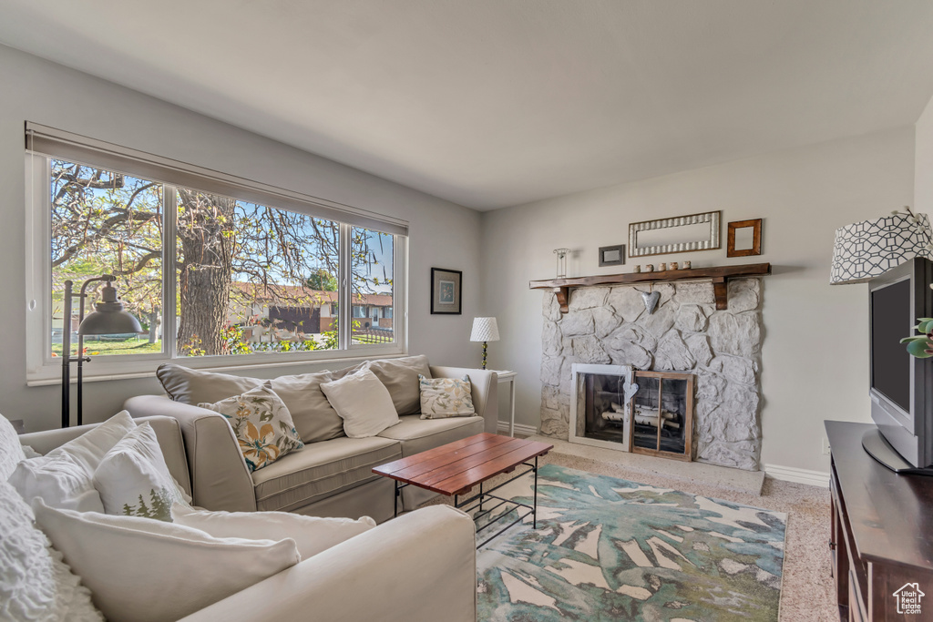 Living area featuring baseboards and a fireplace
