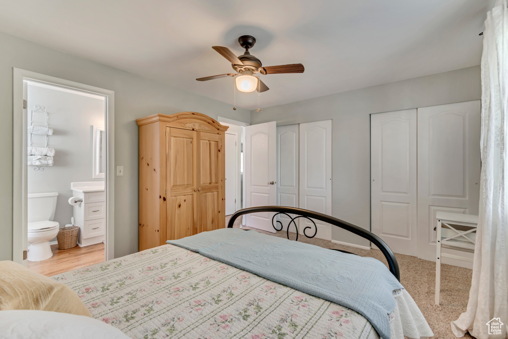 Bedroom with a ceiling fan, connected bathroom, and two closets