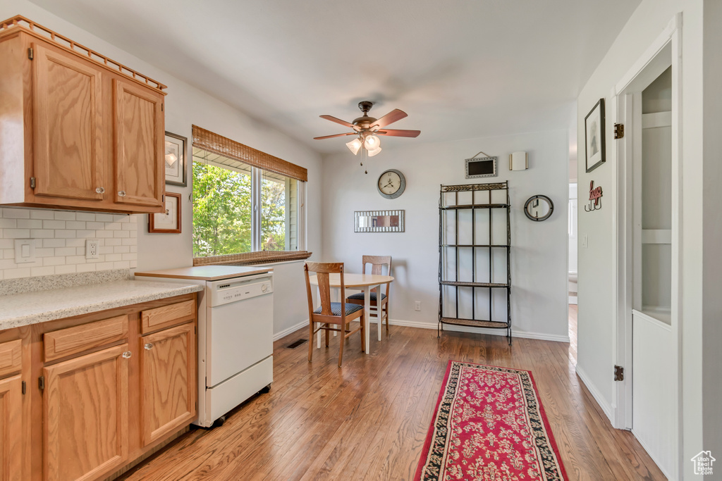 Kitchen featuring tasteful backsplash, dishwasher, light countertops, a ceiling fan, and light wood-type flooring