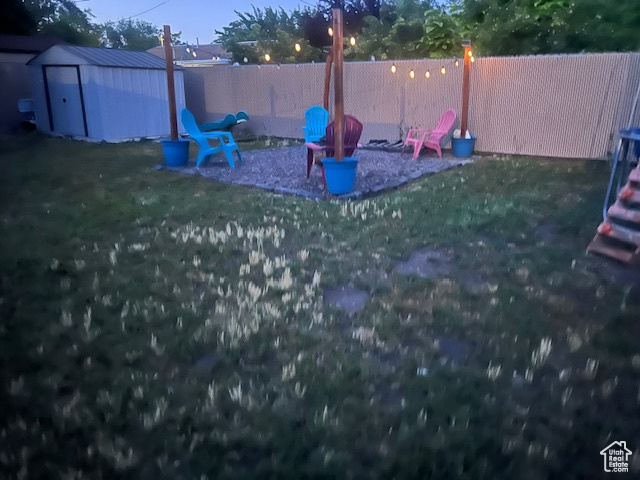 Fenced backyard with a storage unit